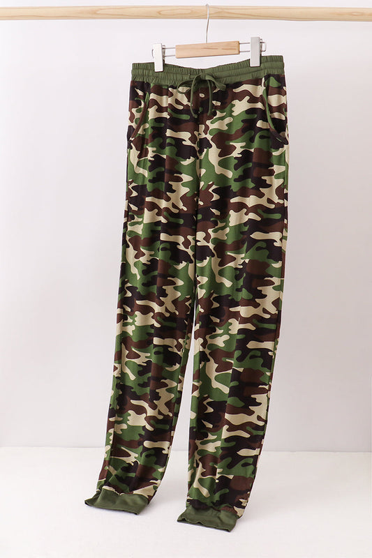 Camouflage pants on a hanger against a white background