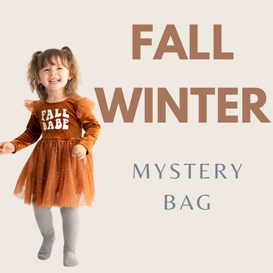 A young girl in a brown 'FALL BABE' dress jumping with the text 'FALL WINTER MYSTERY BAG' on the image.